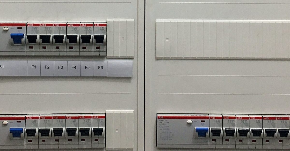 Rows of ABB miniature circuit breakers and RCBOs mounted and labelled inside a distribution board